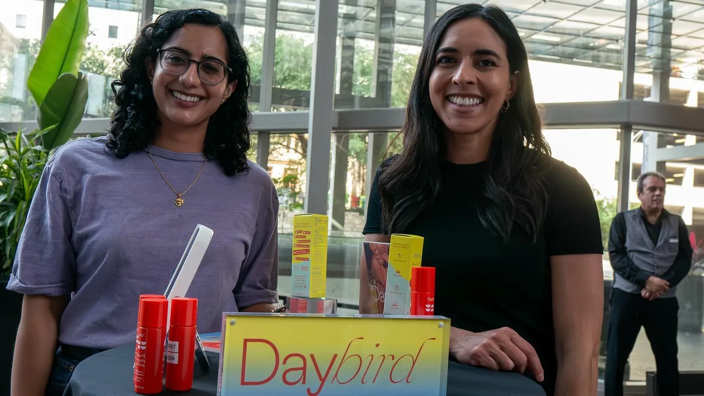 Two brand representatives behind a colorful product display