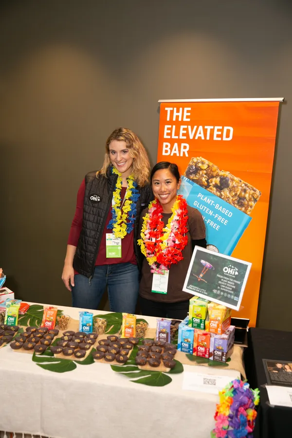Brand representatives behind a product display at Pitch Slam
