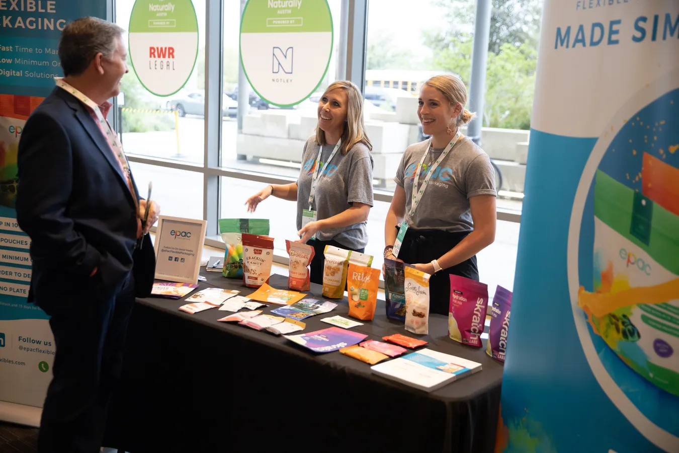 Attendees exchanging ideas beside a product display at Pitch Slam